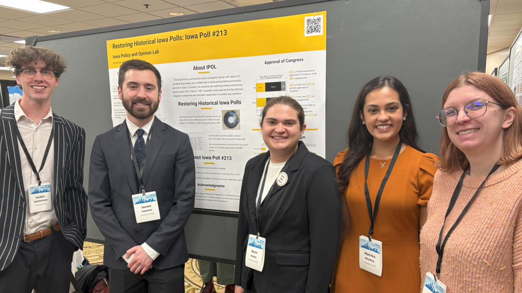 IPOL students presenting our research poster at the MPSA conference